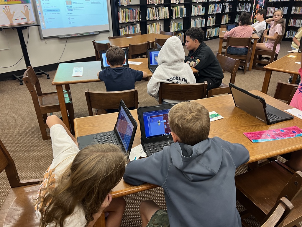 Students work at stations during library time this week. 