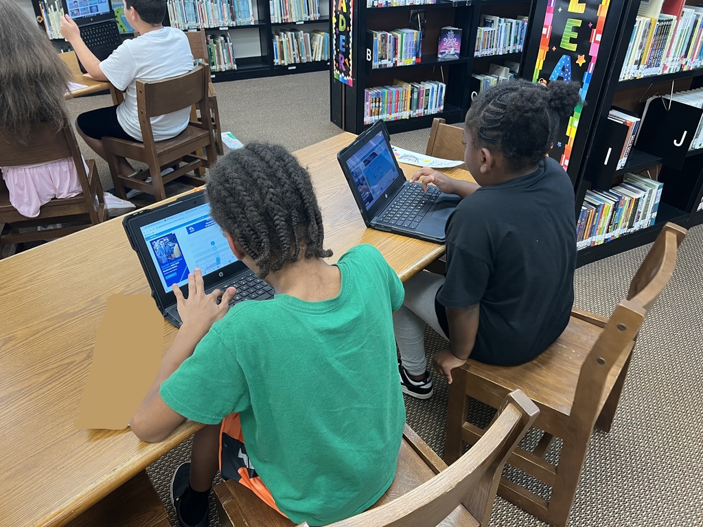 Students work at stations during library time this week. 