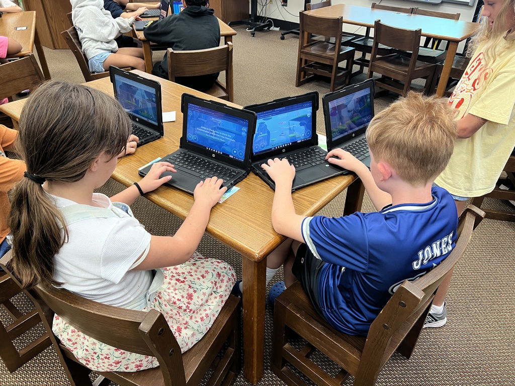 Students work at stations during library time this week. 