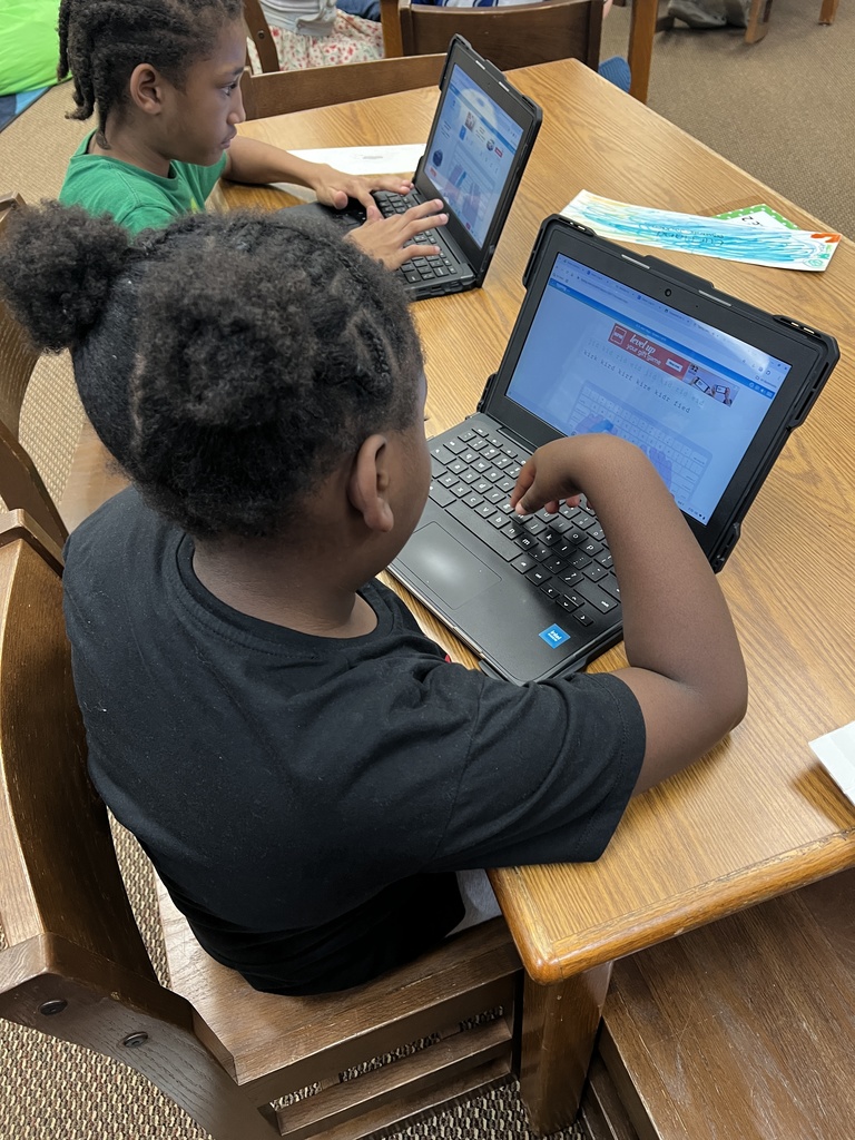 Students work at stations during library time this week. 