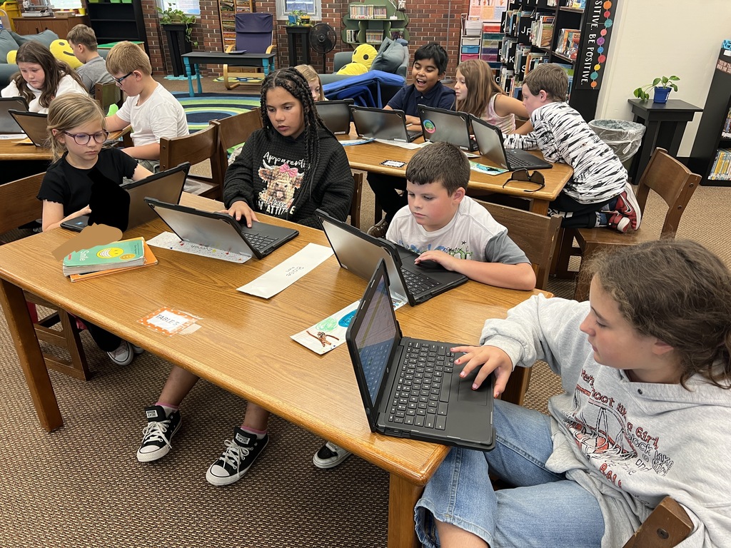 Students work at stations during library time this week. 