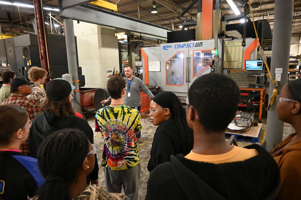 Students listen as an employee talks about IT's part in keeping equipment running.
