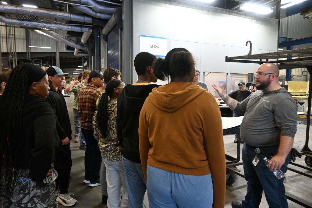 An employee details one of the aspects of parts being made.