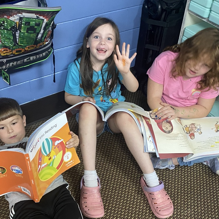 Students reading from their textbook