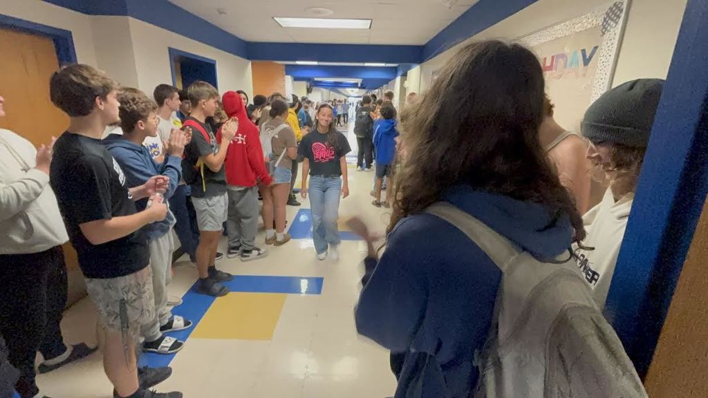 Kadence Ball walks the hall of PHS where she is cheered on by students and staff.
