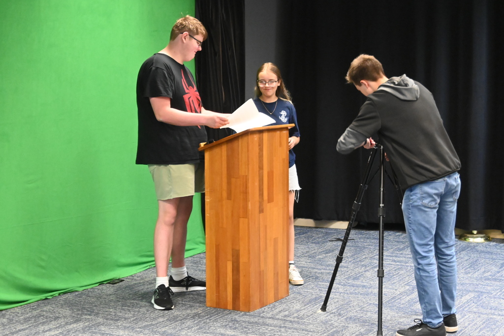 A student prepares to do his segment for Viking News while equipment is being set up.