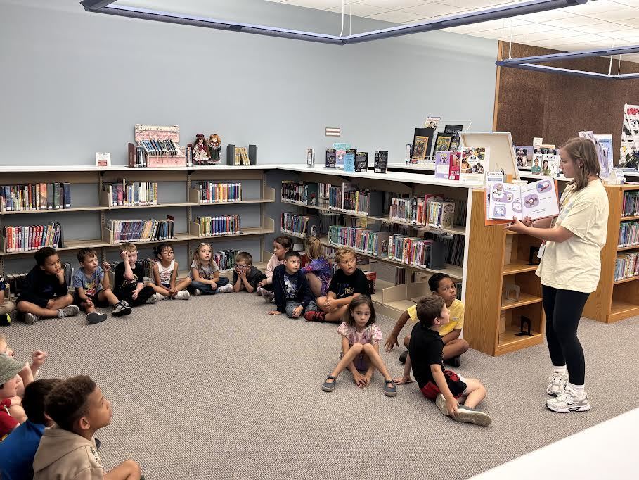 Mrs. Manley reads a Halloween story to students.