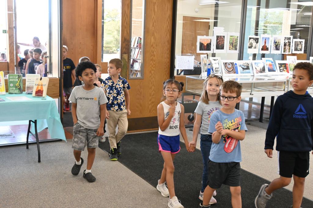 First grade students enter the library.