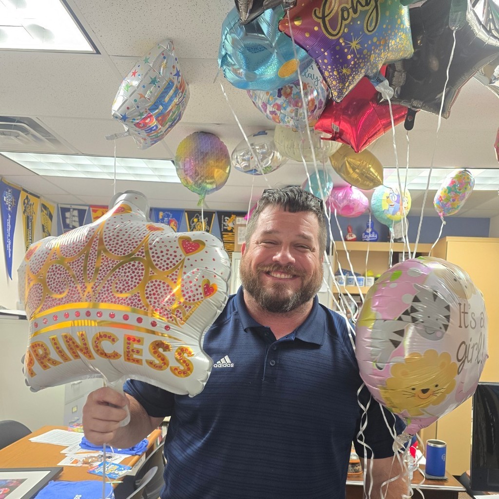 smiling man holding balloons