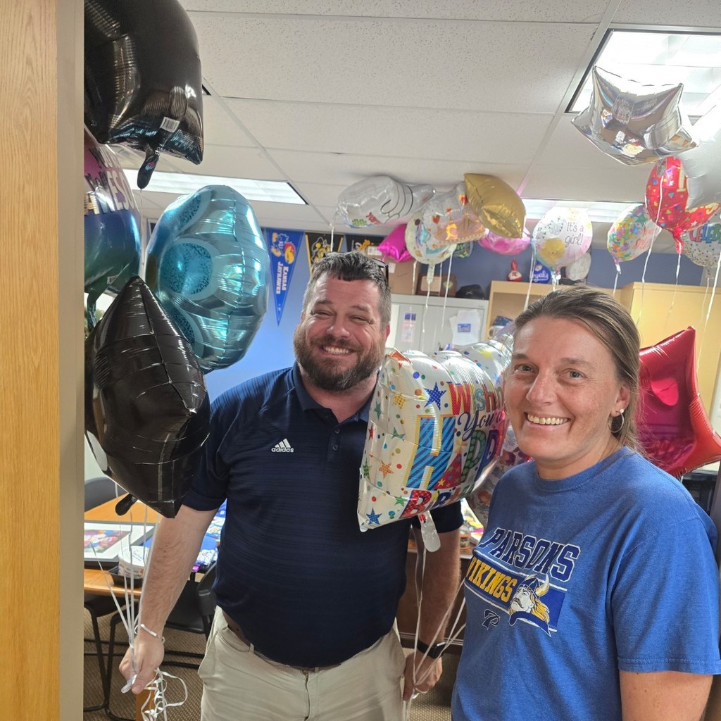 woman and man holding balloons