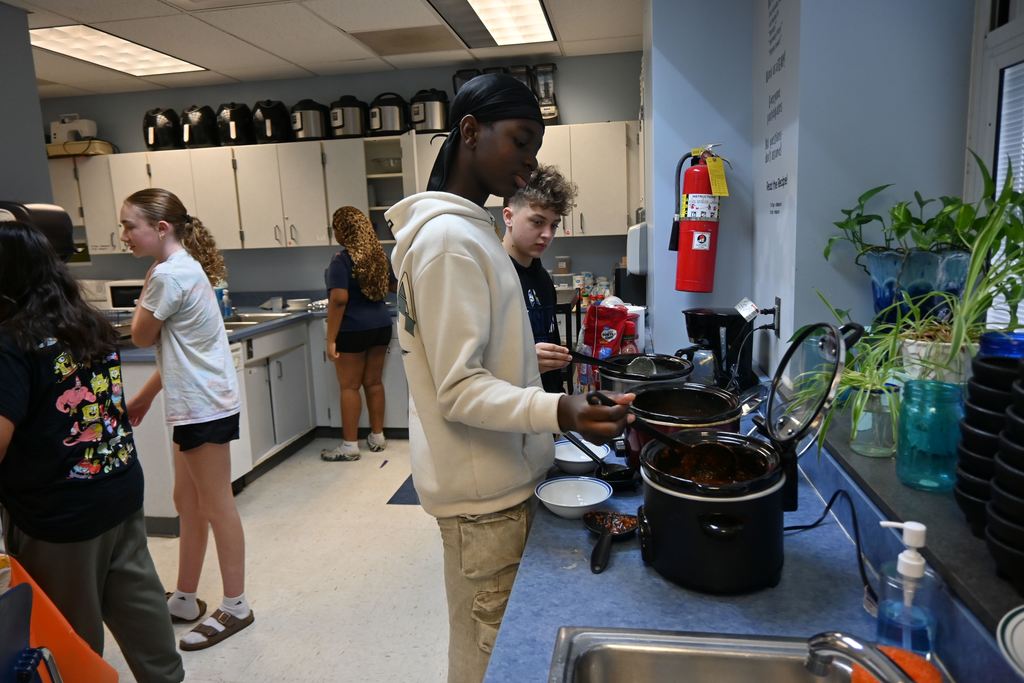 Students check out the soups available to judge.
