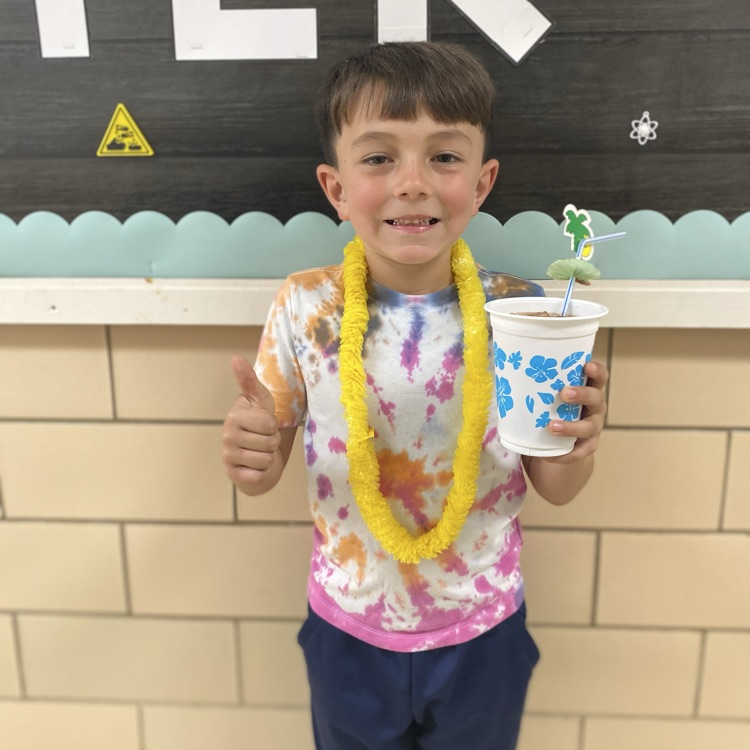 student with a flower lei and a drink