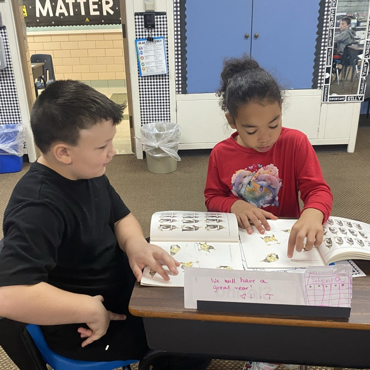 two students reading together