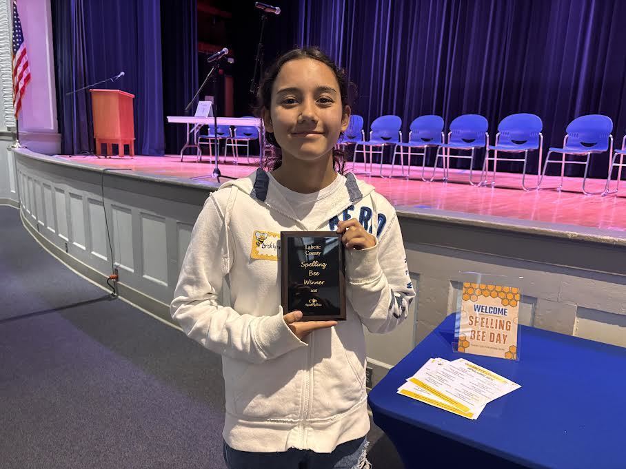 Brooklynn Hiben holds her Championship plaque.