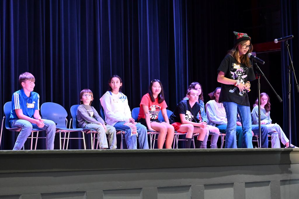 A student spells a word for the judges.