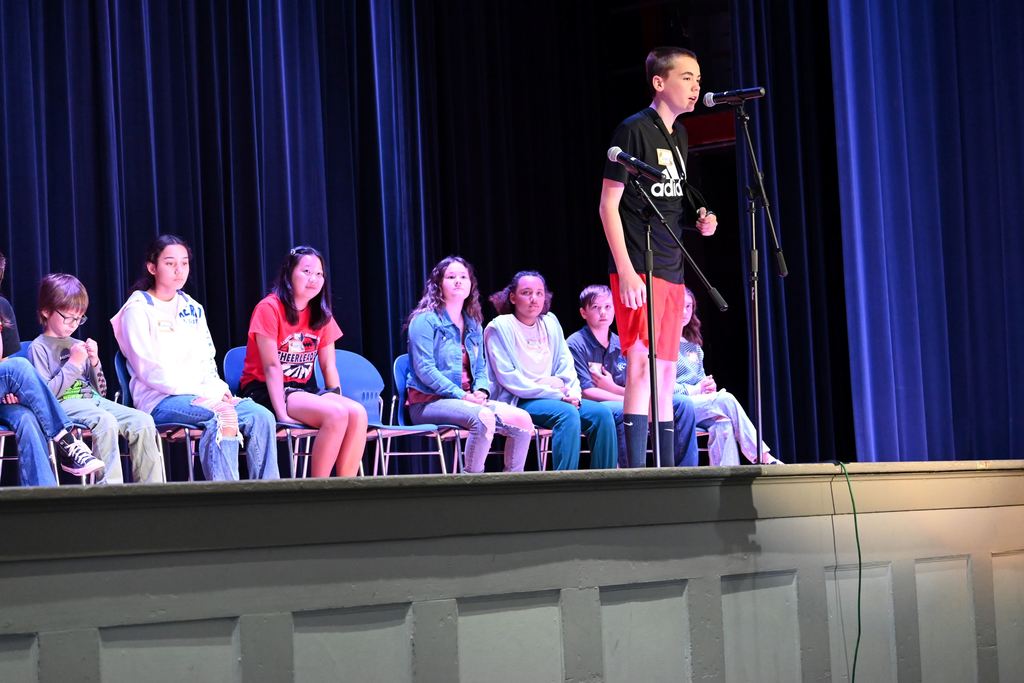 A student spells a word for the judges.