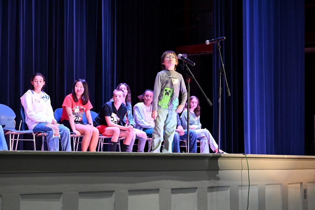 A student spells a word for the judges.