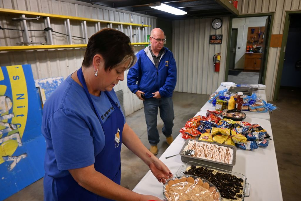 Lori Perkins uncovers desserts as Giefer makes sure everything is ready for his staff.