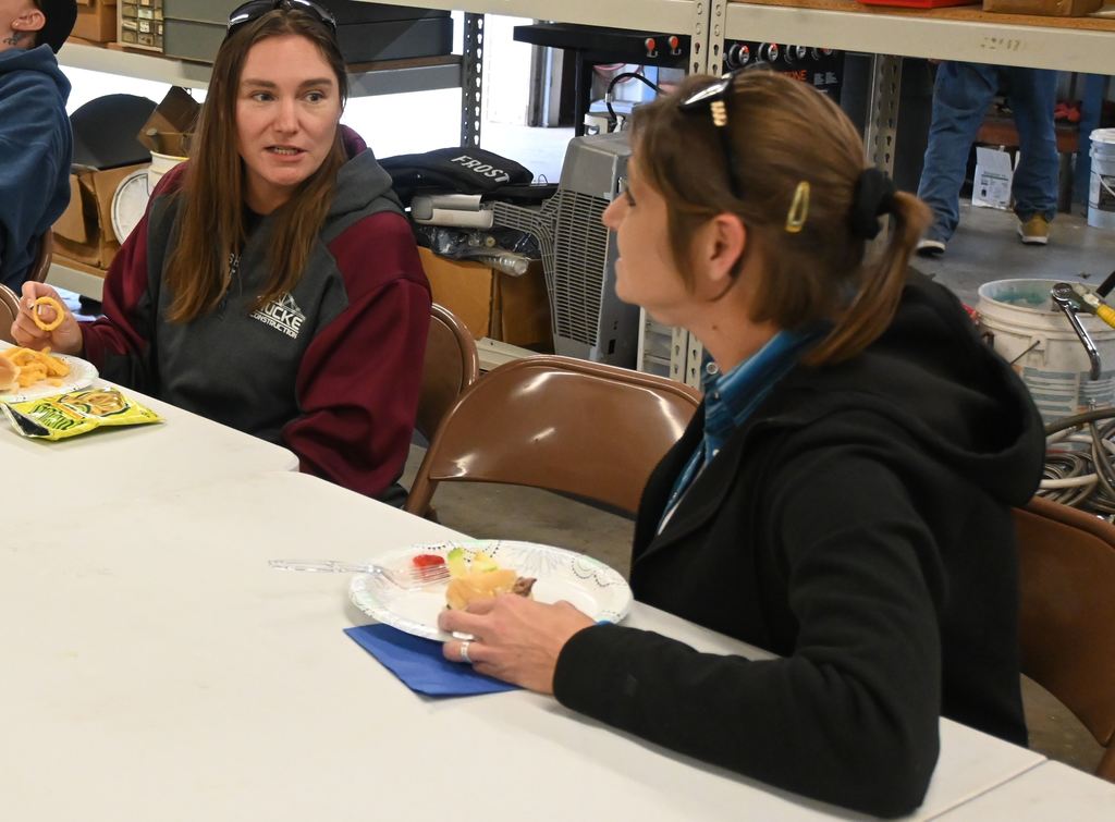 Two transportation staff visit at lunch.