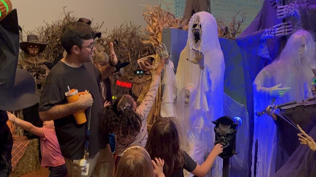 Cody Holmes lets a student give a high five to a ghost.