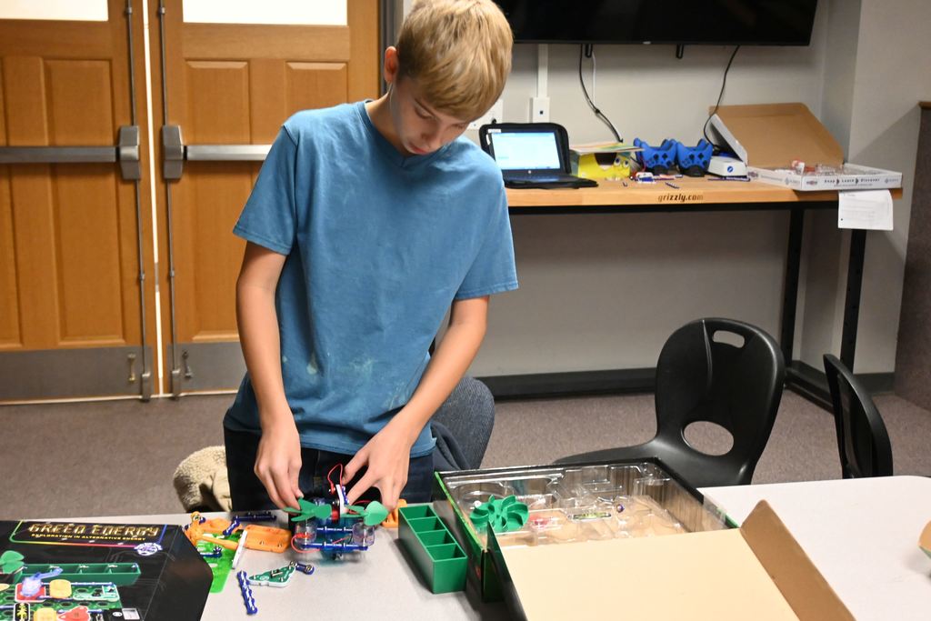 A student attaches a motor,
