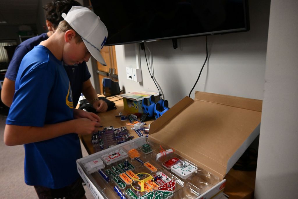 Two students set up circuitry.
