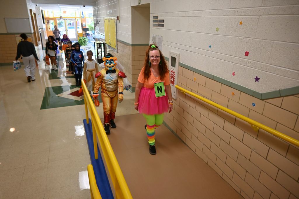 A teacher is dressed as the element Neon.