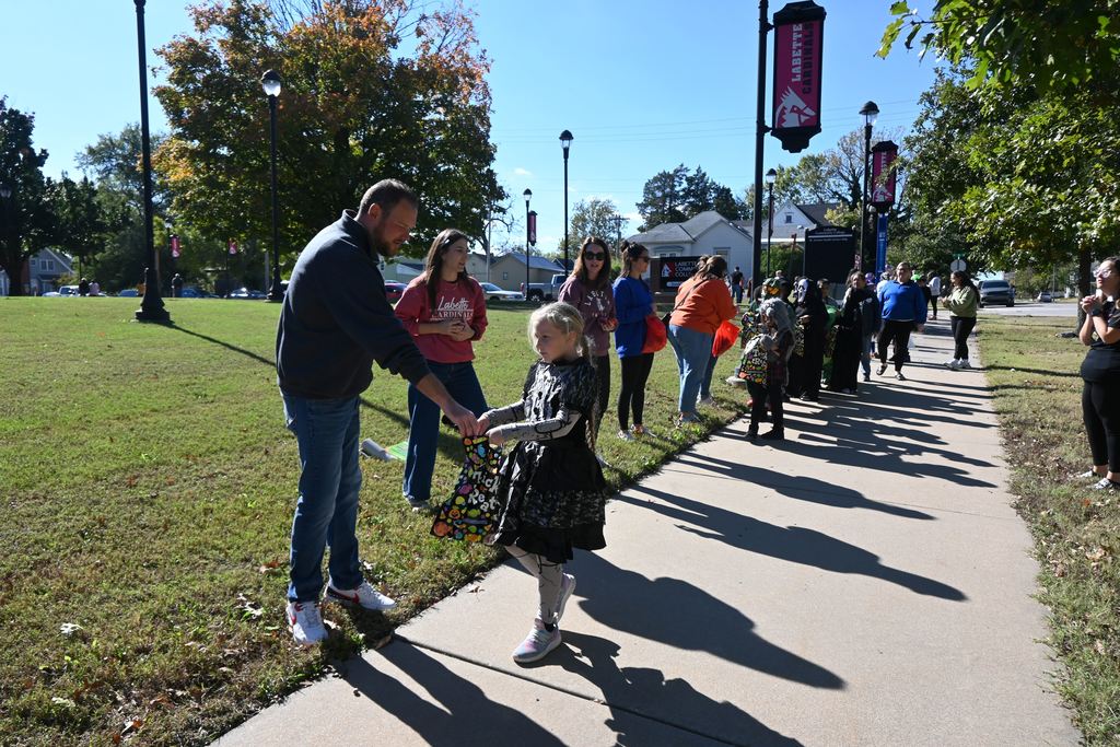 Students in costume receive treats from staff and students at LCC.