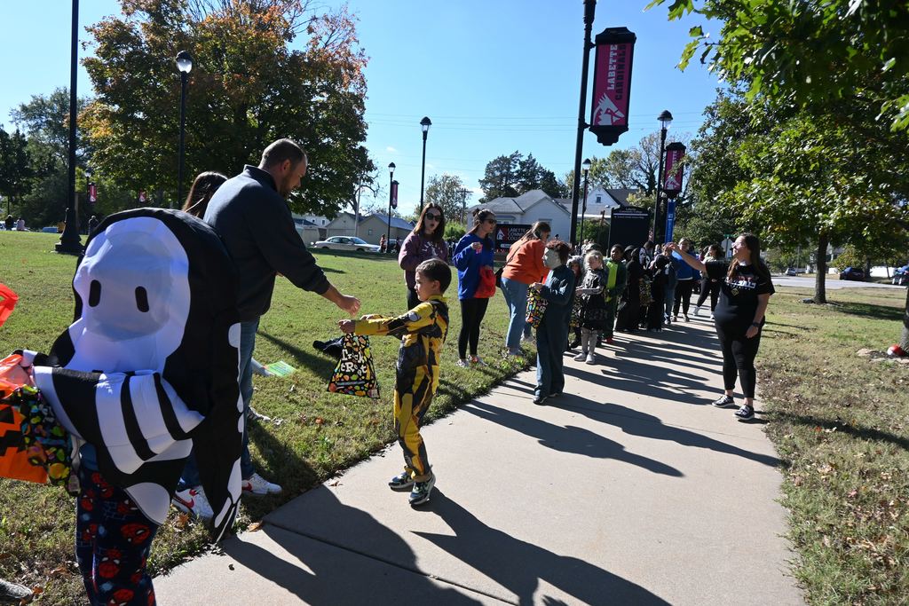 Students in costume receive treats from staff and students at LCC.