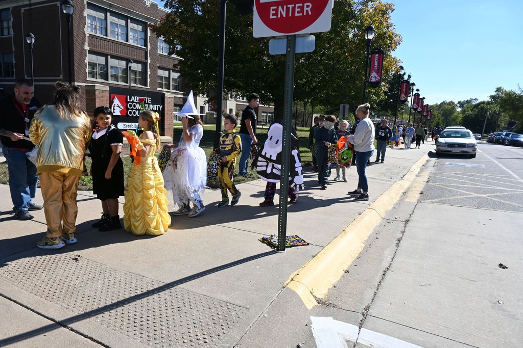 Students and staff at LCC greet students and hand them goodie bags.