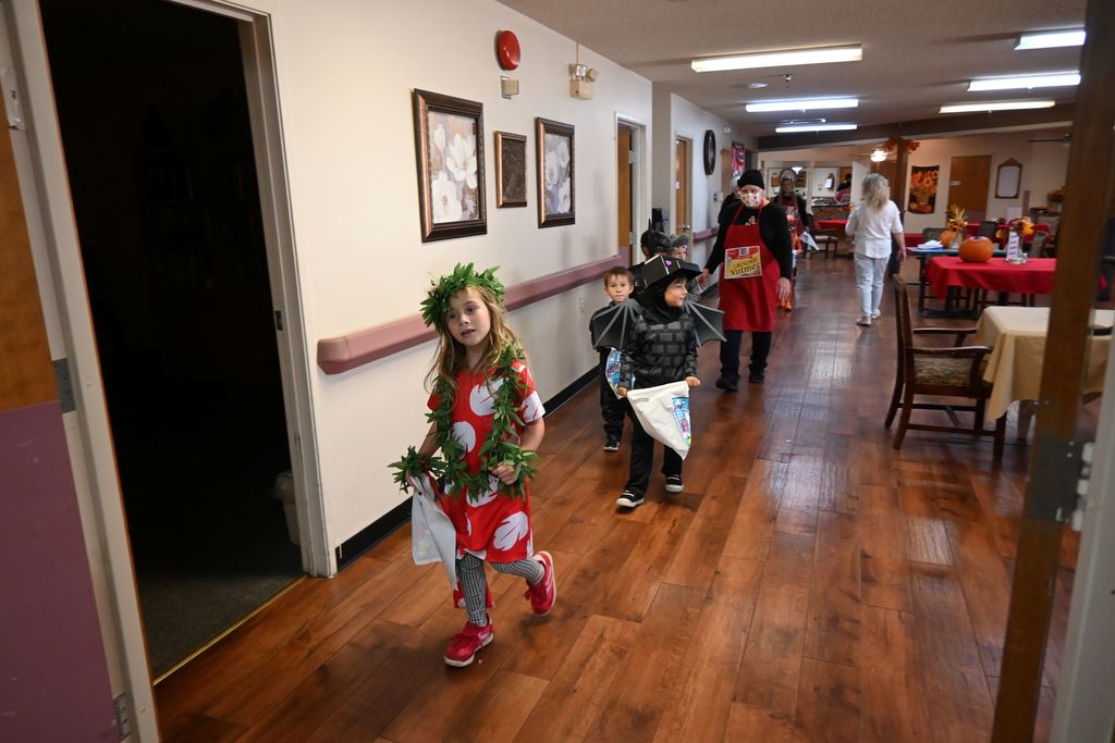 Kindergarten students tour Elmhaven to show residents their costumes.