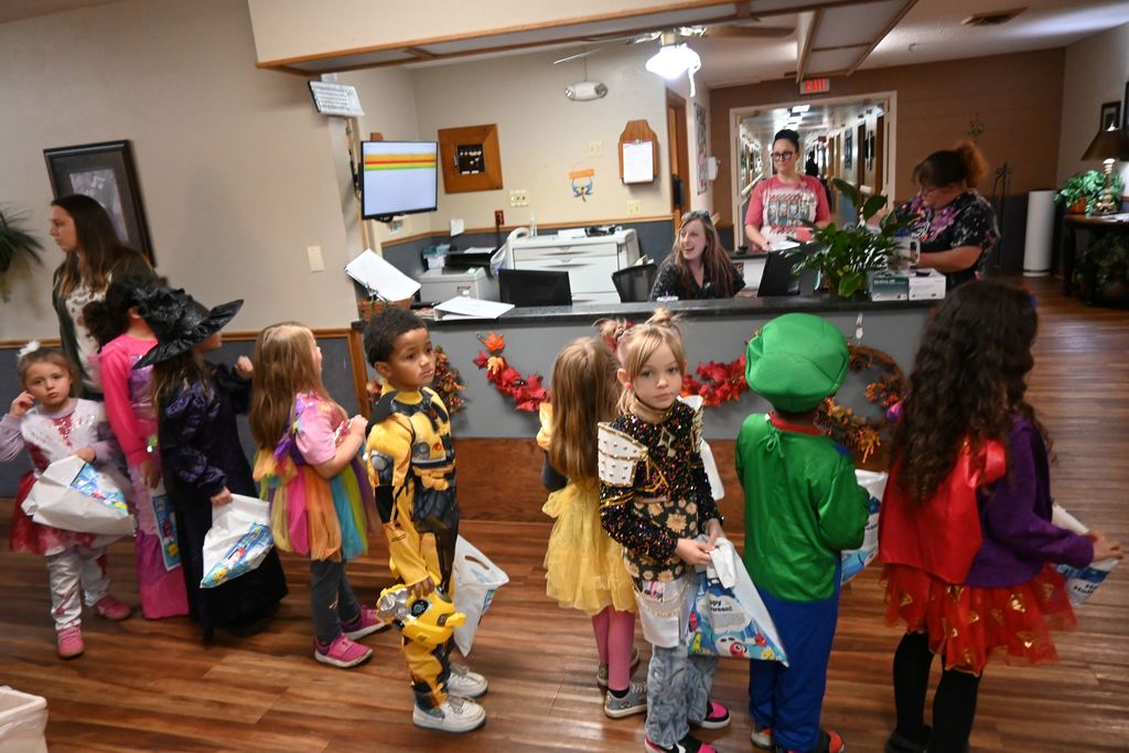 Kindergarten students tour Elmhaven to show residents their costumes.