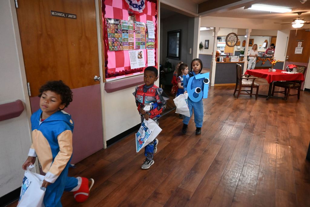 Kindergarten students tour Elmhaven to show residents their costumes.