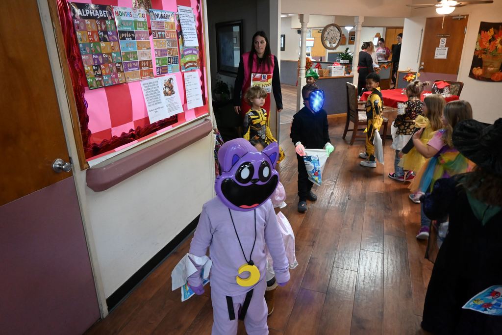 Kindergarten students tour Elmhaven to show residents their costumes.