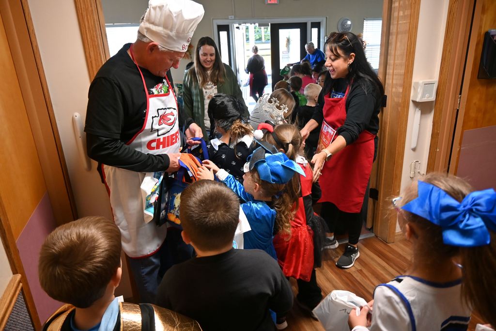 Children receive goodie bags as they leave.