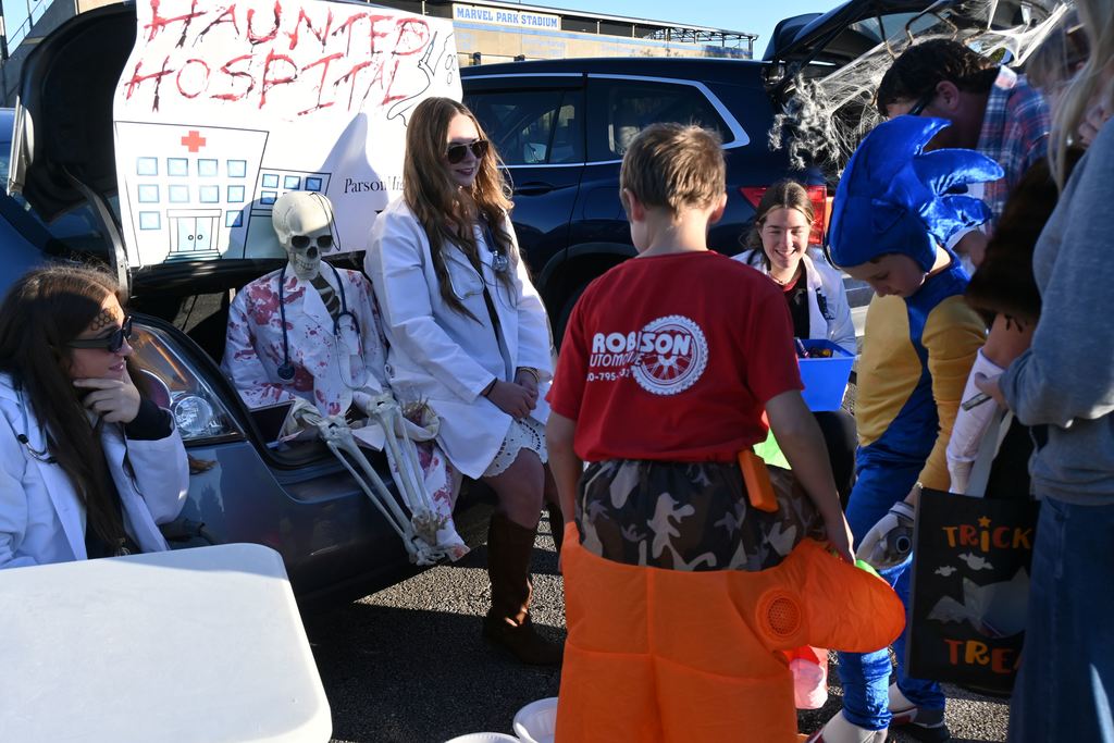 HOSA students talk to Trick or Treaters.
