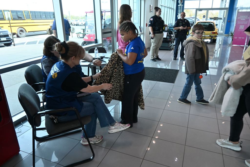 Walmart employees cut tags off coats.