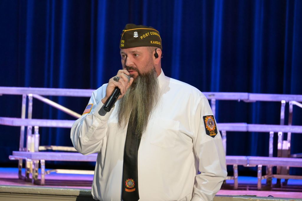 VFW 704 Post Commander Neil Springer speaks to Parsons Middle School students and staff, as well as other veterans in attendance.,