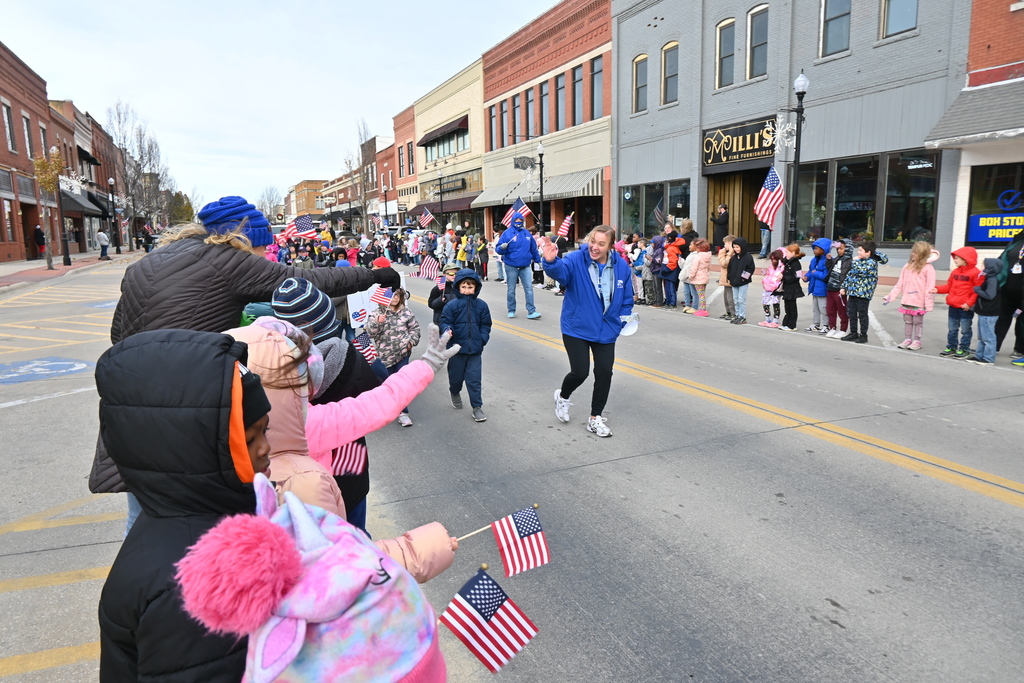 Lincoln first grade teachers and students wave at Garfield students and teachers  lining the parade route.