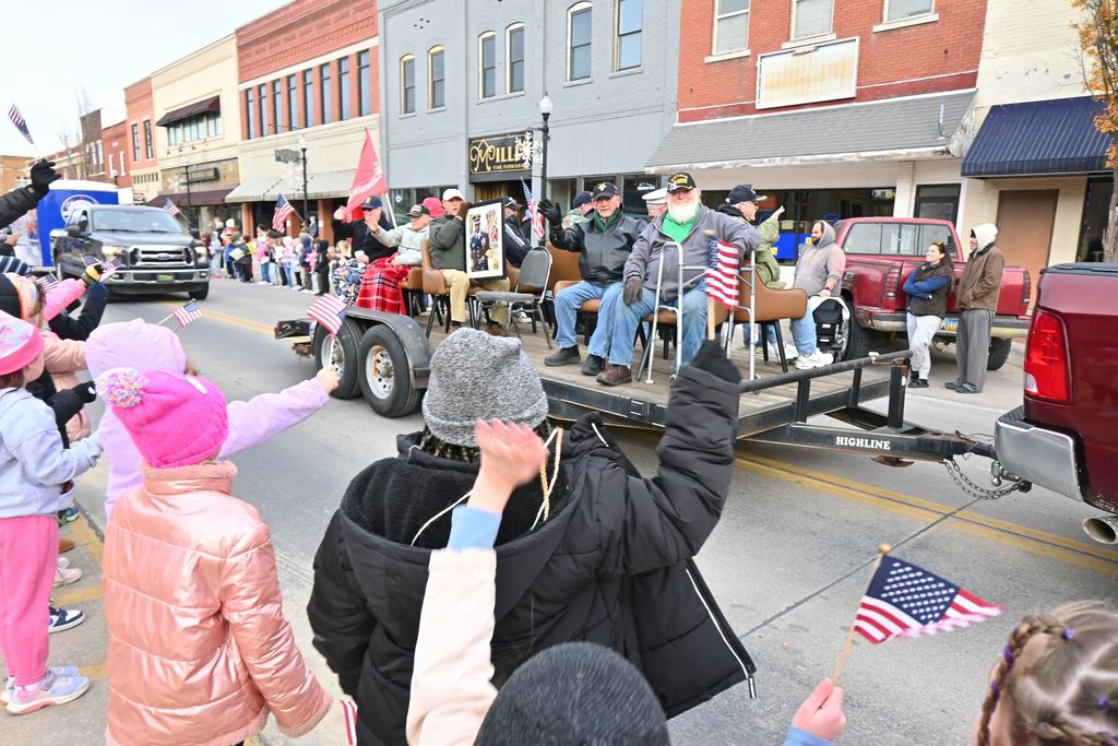 Garfield students wave flags at veterans in the parade.