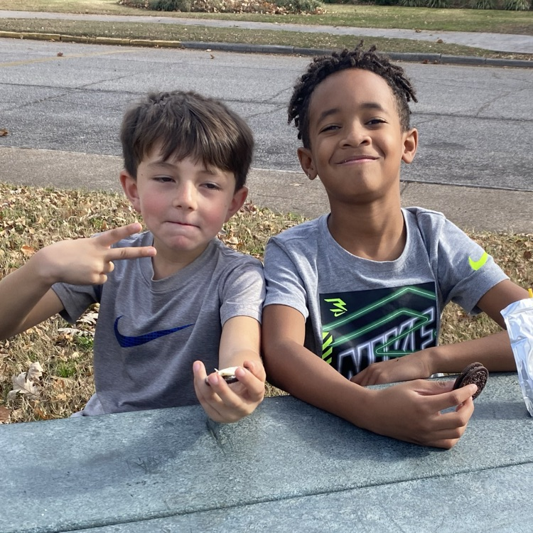 students eating a snack at the park 