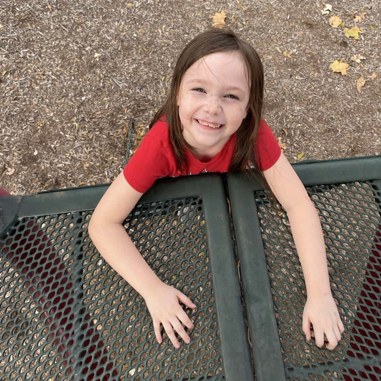 student on playground equipment 