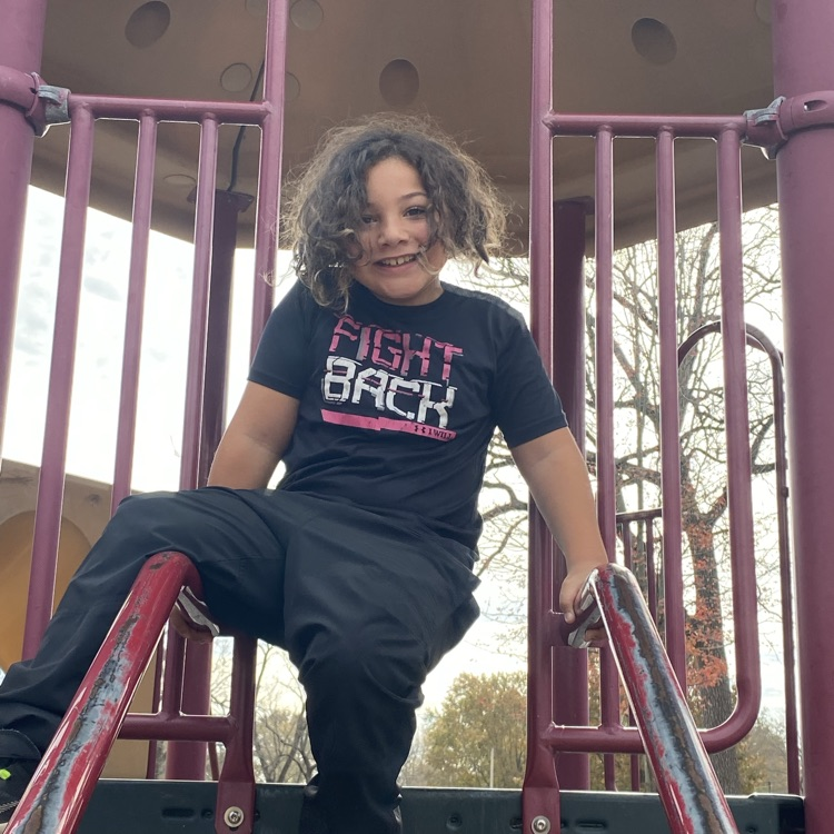 student on playground equipment 