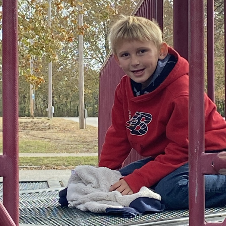 student on playground equipment 