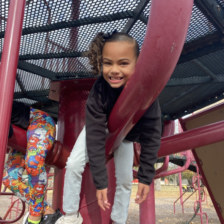 student on playground equipment 