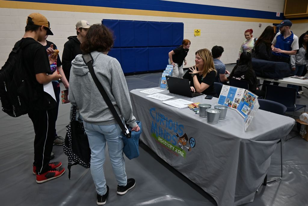 Students visit with someone from Curious Minds.