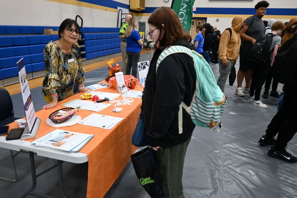 A studnt visits with a business.