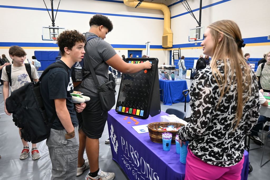 Students visit with someone from Presbyterian Manor.