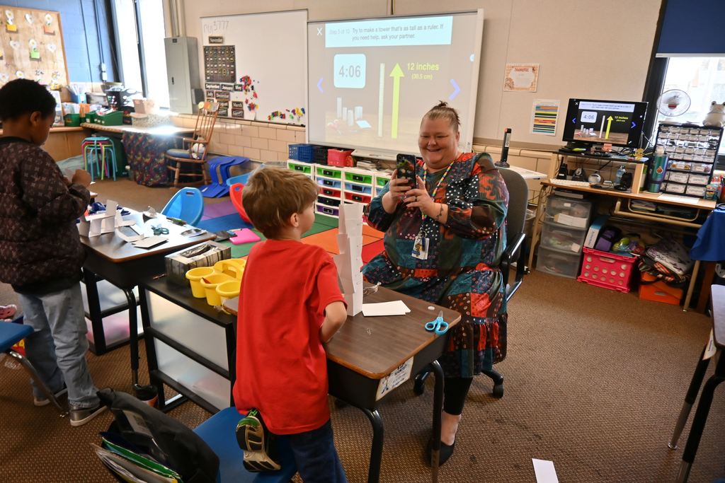 Mrs. Strode grabs a picture of the first student to succeed.