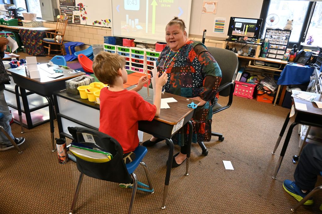 A student meets the challenge of his tower being taller than a ruler.